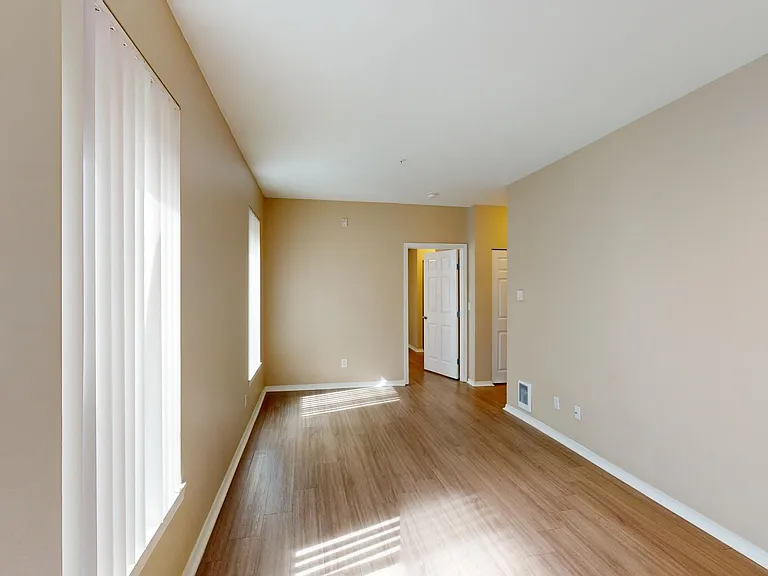 Apartment living room with wood-style flooring.