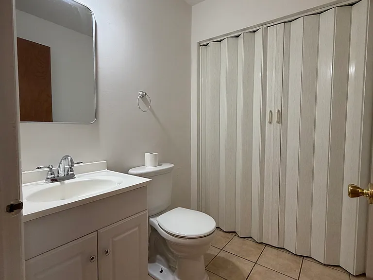 Half a bath on the first floor with a laundry area