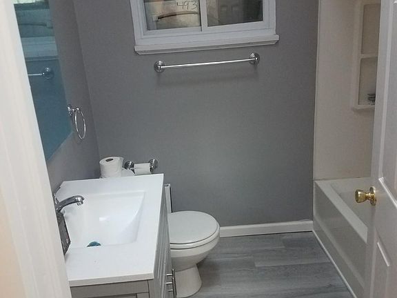 Remodeled bath with large wall radiator which can be used as a towel heater