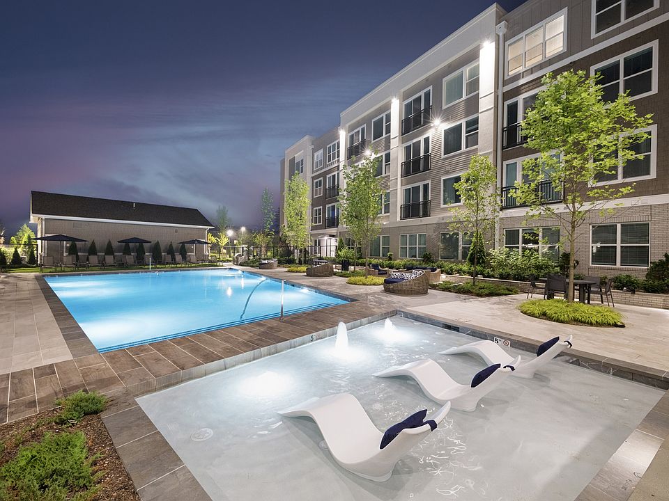 Resort-style pool outfitted with daybeds and sun loungers