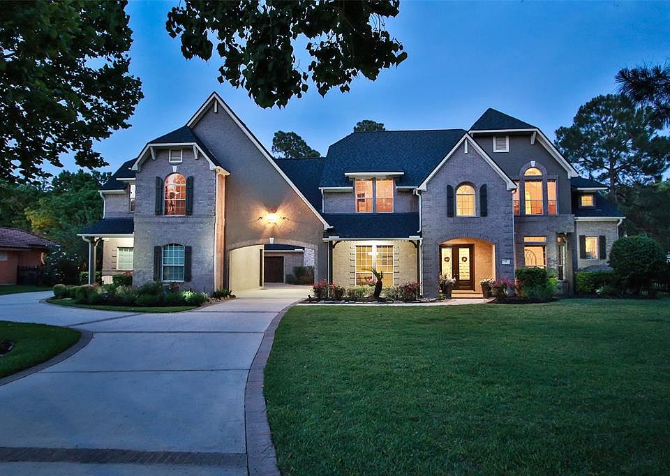 Large arched, covered front porch with brick surround. Double lead glass doors greet you.