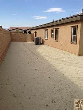 Side yard with gate and door to garage