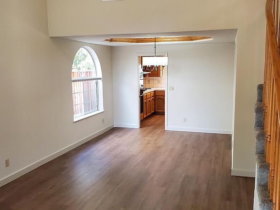 Front-door opens to large living room and dining room open space.
