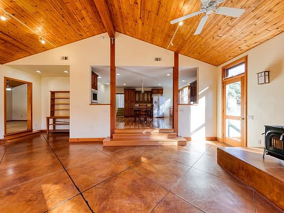 __ Warm & Spacious Living Room
Featuring vaulted cedar ceilings, open beams, and polished concrete floors, this sunlit space offers rustic charm with modern touches.