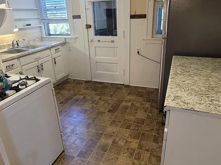 Kitchen with Gas Stove new refrigerator Back door to aback Hallway With a small porch off the kitchen