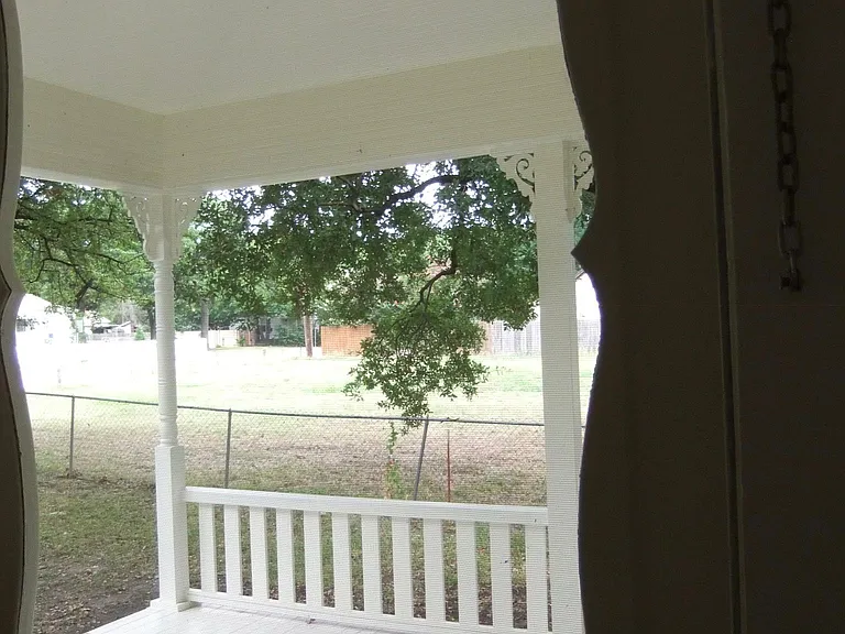 View of front porch on to public park on South side of house