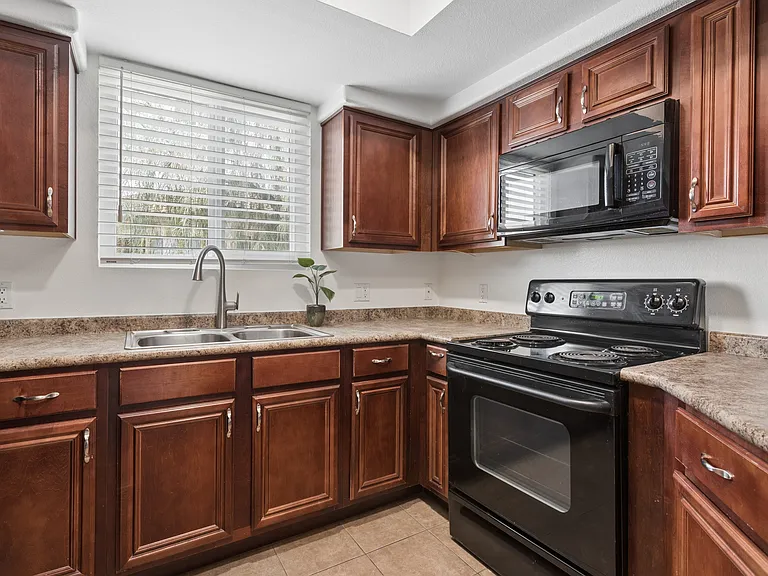 Modern kitchen faucet; microwave oven in your well-lit kitchen