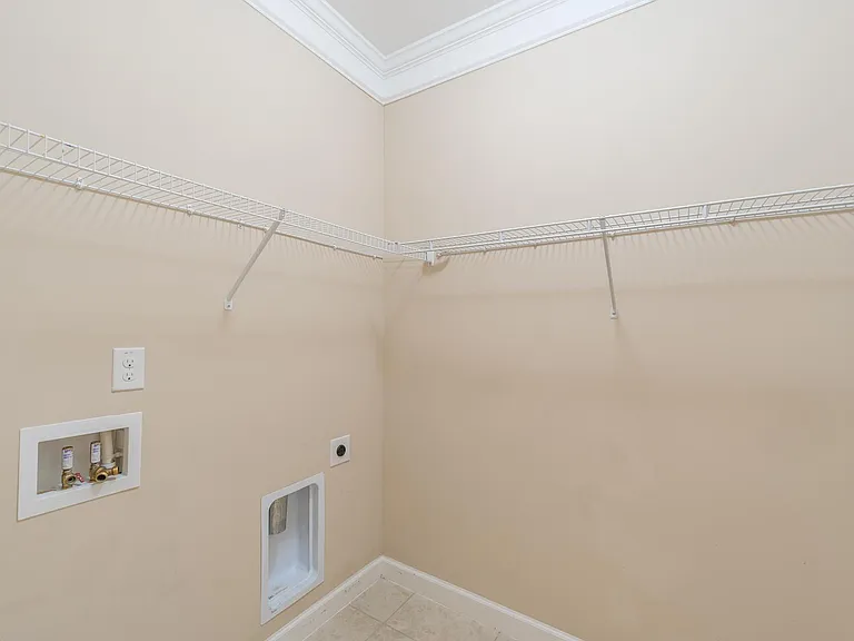 laundry room with connections for washer & dryer, comes with wire shelves