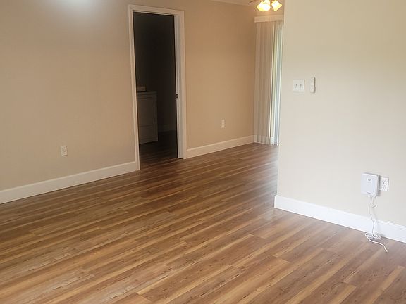 Part of living room with new ceiling fan floor and moulding