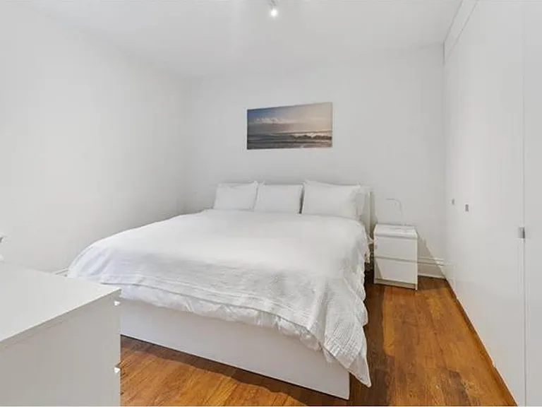 bedroom 1 with custom built in shelves