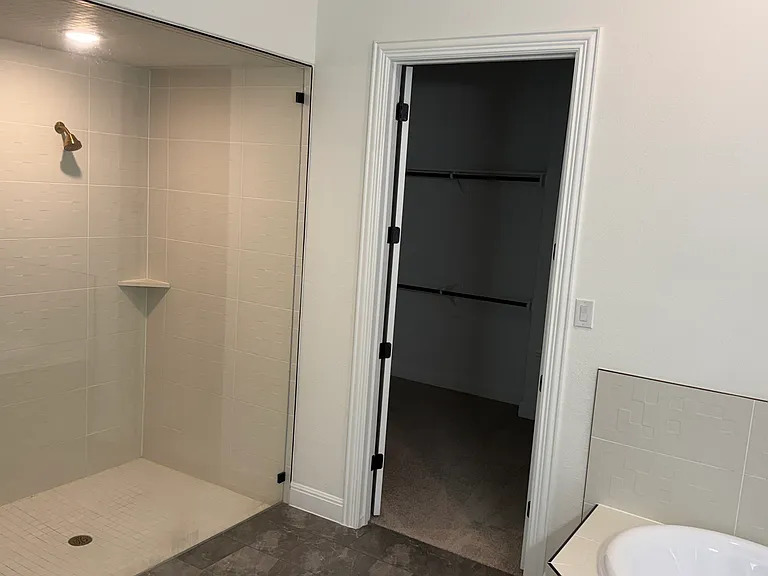 Main bathroom with oversized two-headed walk in shower