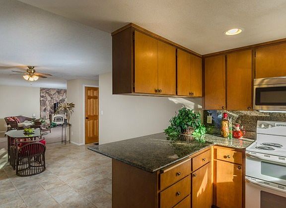 Kitchen is open with a breakfast bar and plenty of space to acco