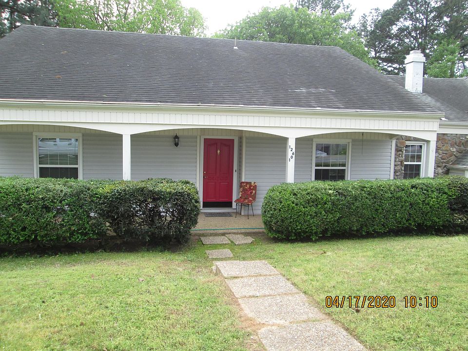 Front of house features covered porch.
