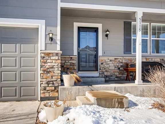 Classic front porch has views of open space.
