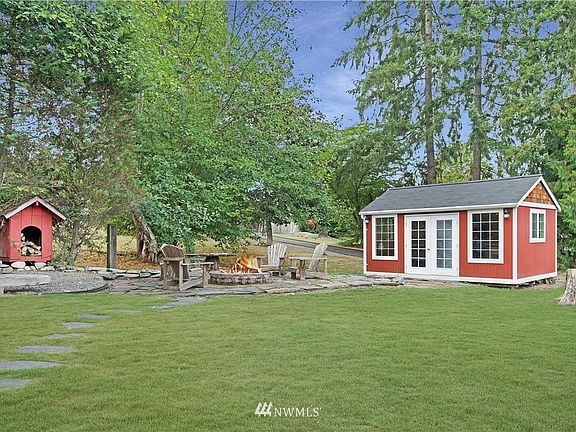 Amazing yard with RV Parking, custom paver patio with built-in firepit, detached finished studio with power, storage shed and custom-built play house!