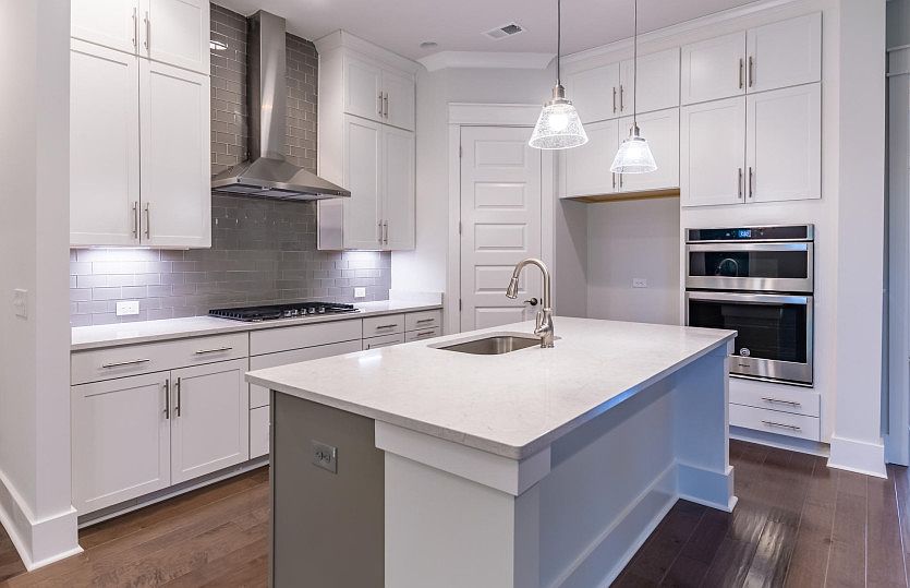 Beautiful Kitchen with a kitchen island and a hooded vent perfect for home cooked meals.