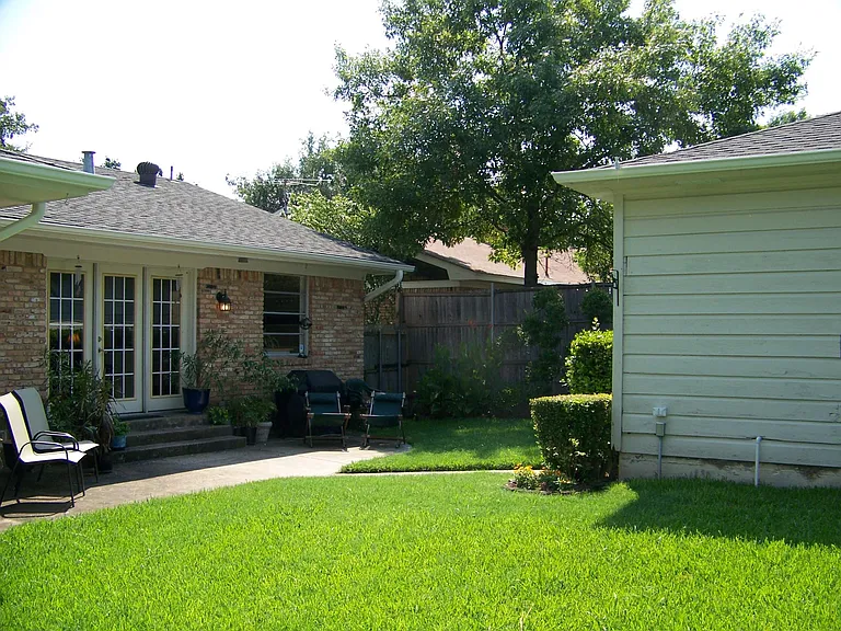 The garage is detached and located through the yard from the backdoor.