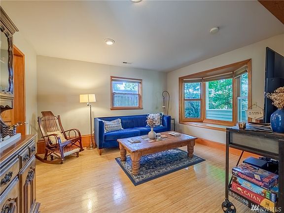 Upon entering the home, this is the living room located off to the right of the entry. It features wood wrapped bay window, Bamboo Flooring and beautiful millwork