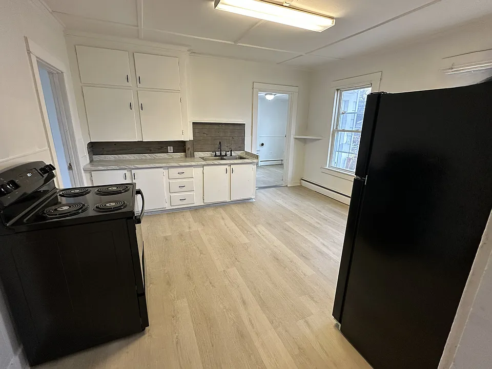 Oversized kitchen with new appliances, counters, backsplash, and flooring