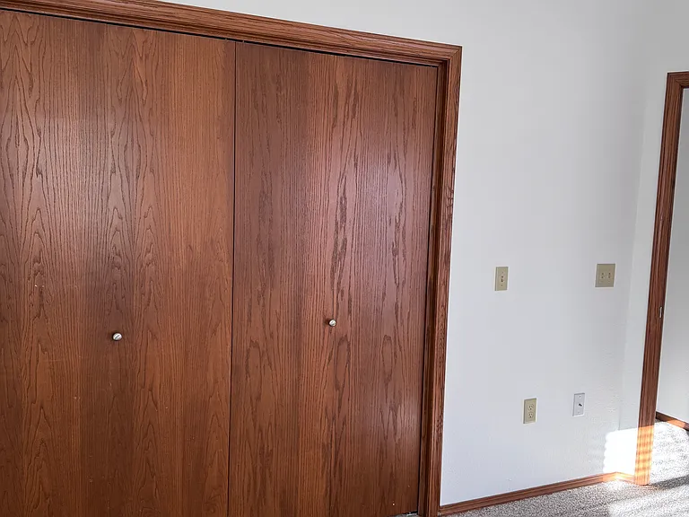 Larger bedroom with vaulted ceiling and back patio door. And large closet.