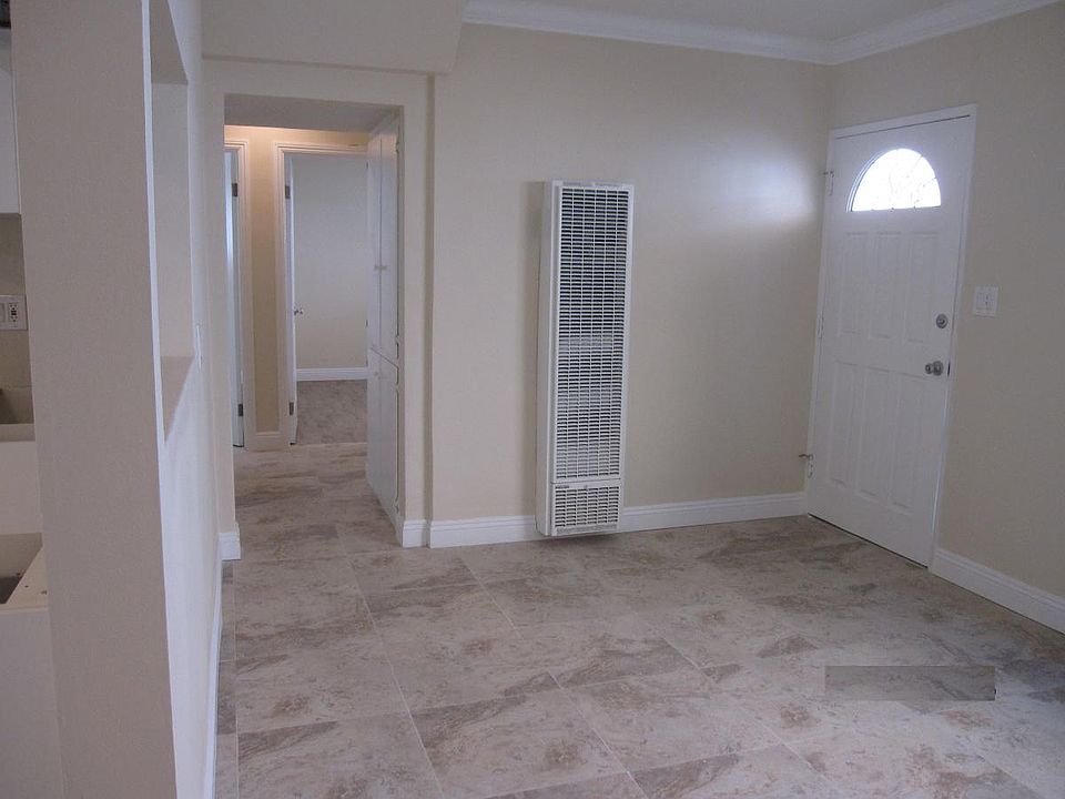 Living area with crown molding and Italian ceramic tiles