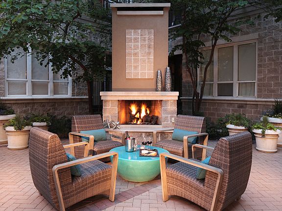 Pool deck equipped with fireplace and ample seating