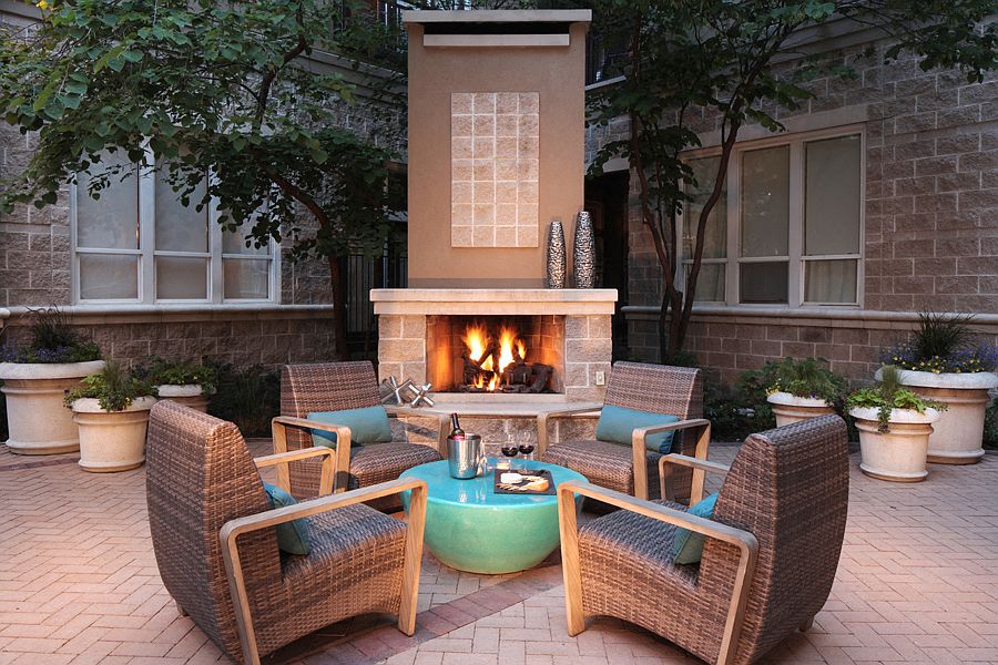 Pool deck equipped with fireplace and ample seating