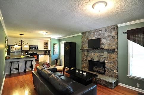 The Stone Fireplace and Glowing Wood Floors Catch Your Eye and Your Full Attention!