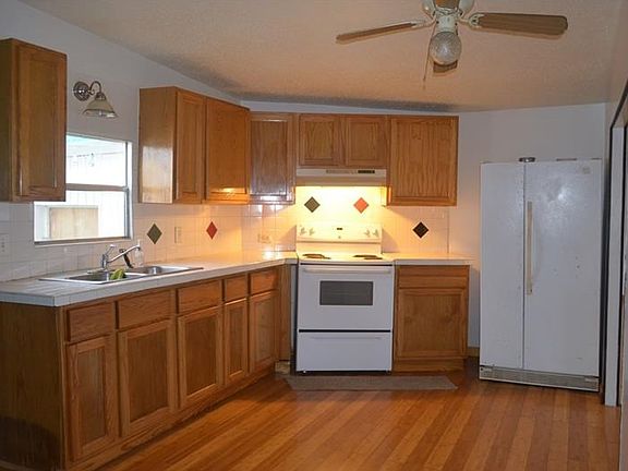 The cook will be happy with tile counter tops, wood cabinetry and a window to let in natural light.