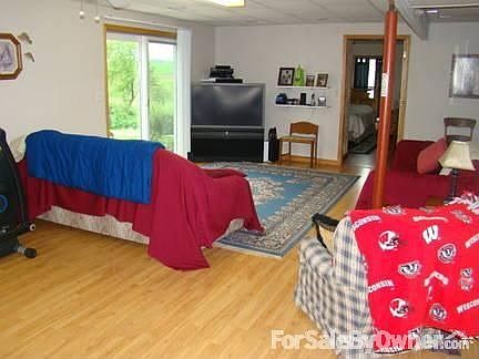 Lower level family room : Laminate fooring. Leads to outdoor patio.