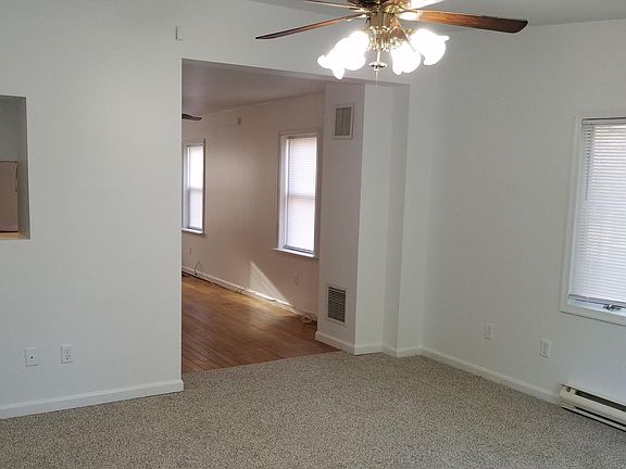 Family room with bay window open to dining room and a kitchen pass through.