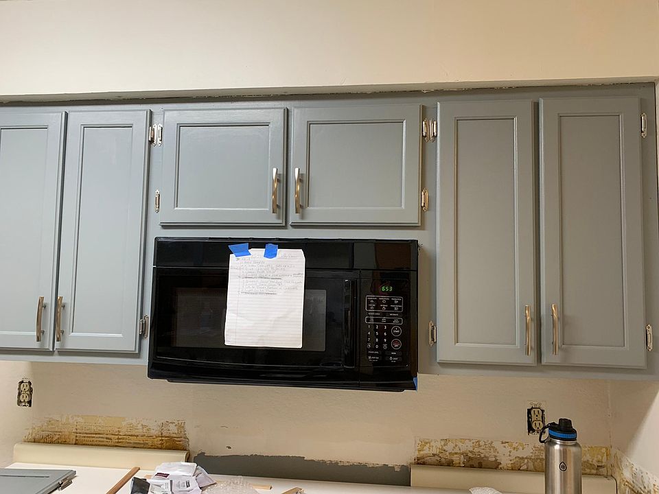 Cabinets over stove, new stove, granite counters and tile backsplash not yet installed due week of 9/1. Tile backsplash goes up to the bottom of cabinets