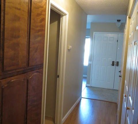 Hallway to Laundry Room, Full Bathroom, Coat Closet, Front Door