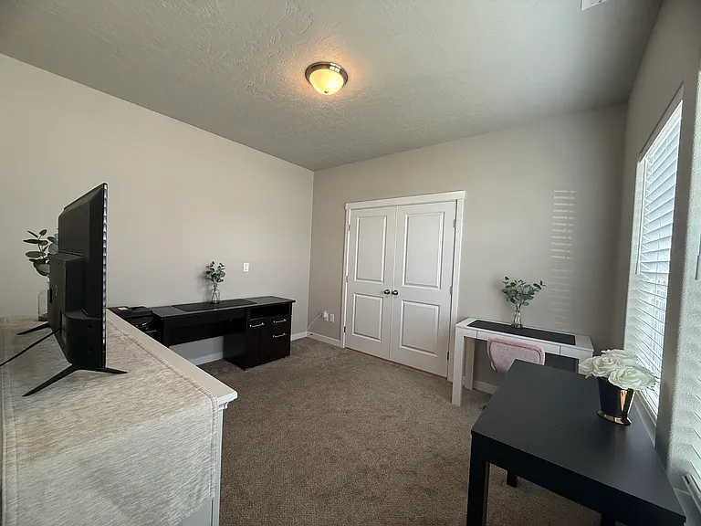 Bright versatile flex room with double door entry that can serve as a home office, kids play room, or a hobby, craft, game room or extra living space.