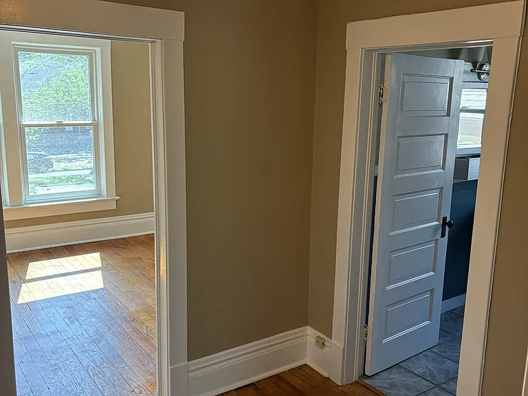Hallway view into bathroom and living room