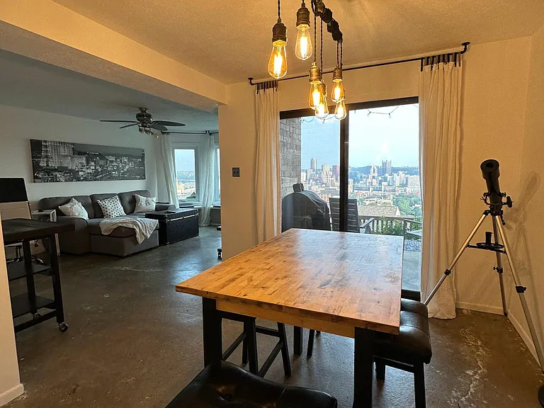 Dining Room as you enter the front door, looking toward the living room. Front porch area on the right via the sliding glass door.