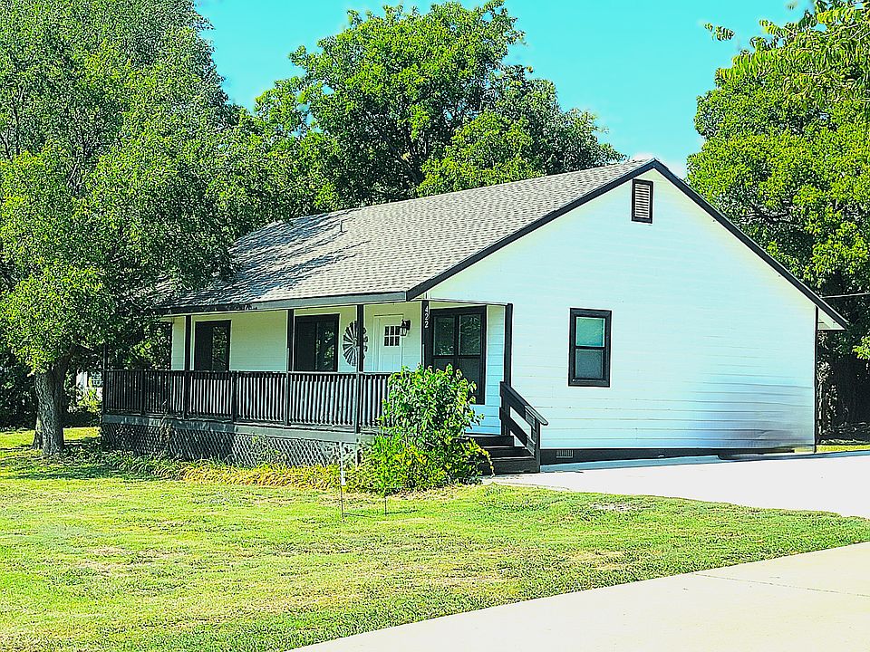 Come on home to this cute house located near everything but on your own private 1/2 acre.