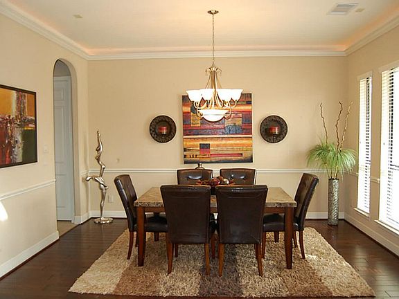 FORMAL DINING ROOM WITH HARDWOODS AND DECORATIVE CHAIR RAILING