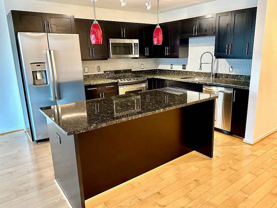Gourmet kitchen with updated GE appliances. Freshly sealed granite counter tops, glass tile backsplash, glass pendent lamps, and a new luxury faucet by Gerber.