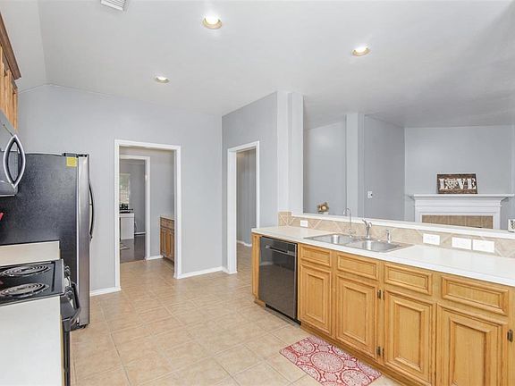 The kitchen has been updated with a recent dishwasher and microwave. The stove is electric, but should you prefer, there is a gas line for a gas cooktop. The lighting is recessed can lights which add to the clean look of the Kitchen.
