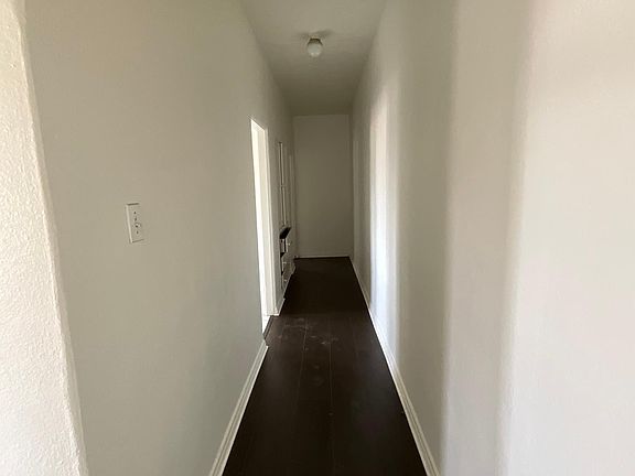 Nice long hallway with wood flooring
