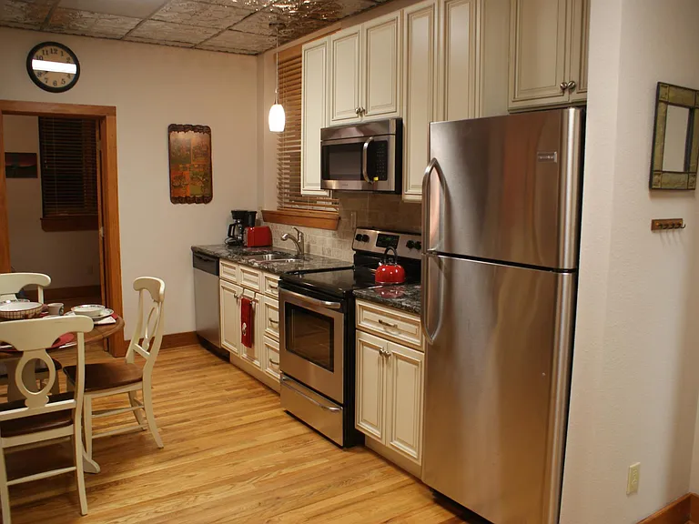 Kitchen furnished with pots, pans, utensils, etc.