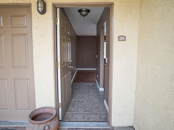 Open entrance with the fridge and kitchen immediately to the right (convenient to drop off your groceries).