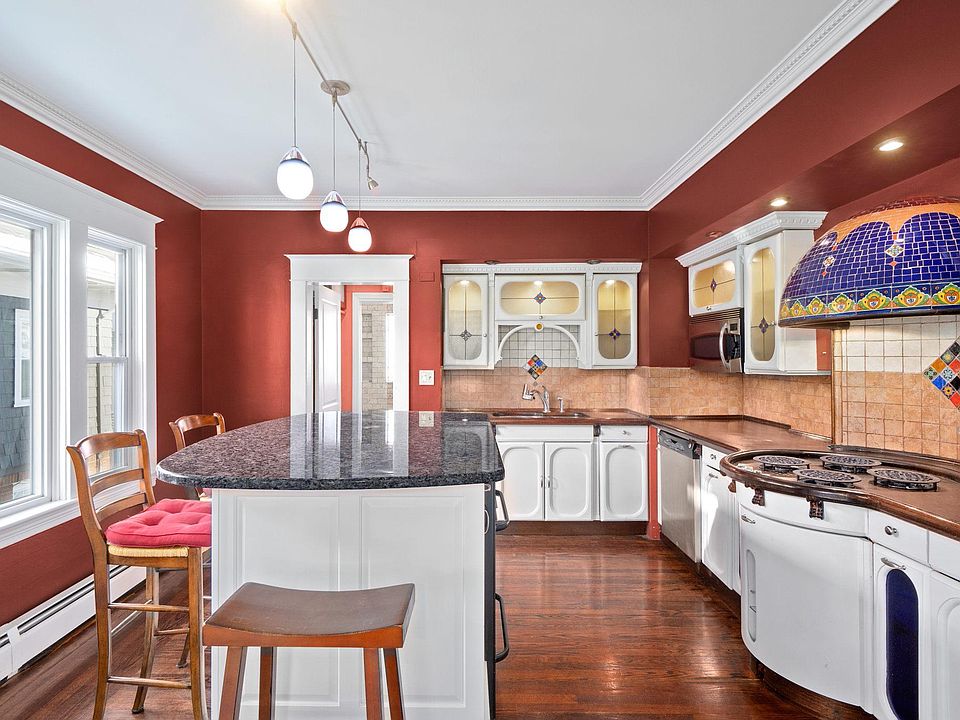 Kitchen. Granite countertop island provides even more storage space.