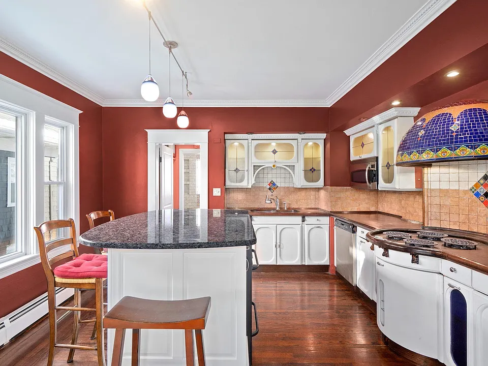 Kitchen. Granite countertop island provides even more storage space.