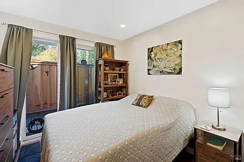 One bedroom with large sliding doors to small private back courtyard. (furniture not included)