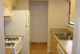kitchen with gas stove, dishwasher and refrigerator.