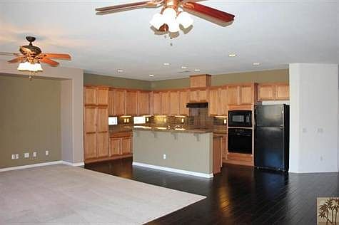 view from dining area to great room and kitchen