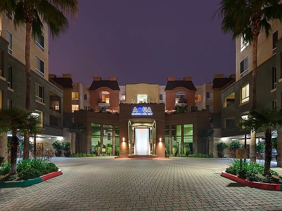 Exterior of apartment building at night.