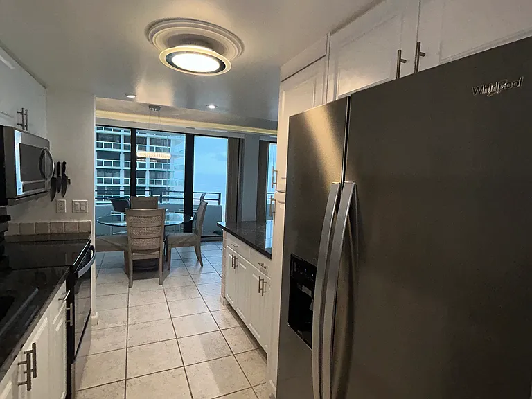 view of new stainless refrigerator in kitchen
